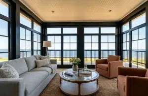Wall solution transforming an unused porch into a comfortable outdoor space.