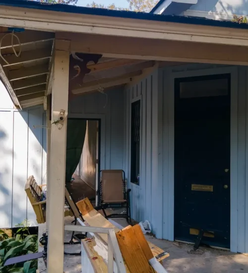 Wall solution transforming an unused porch into a comfortable outdoor space.